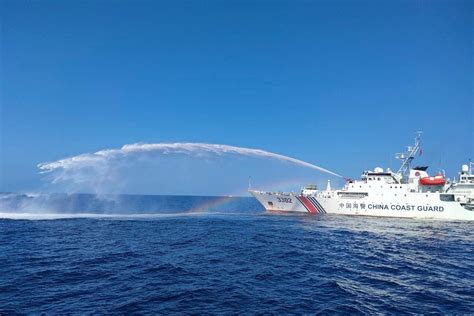 Chinese coast guard ships fire water cannons and block .